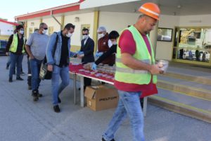 Employees receiving a traditional gift of baklava